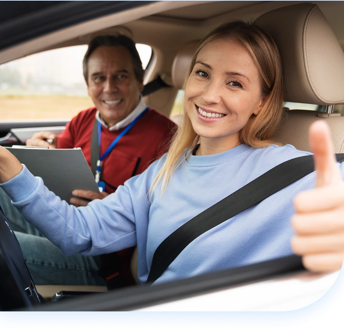 girl giving thumbs up inside car(mobile) girl giving thumbs up inside car